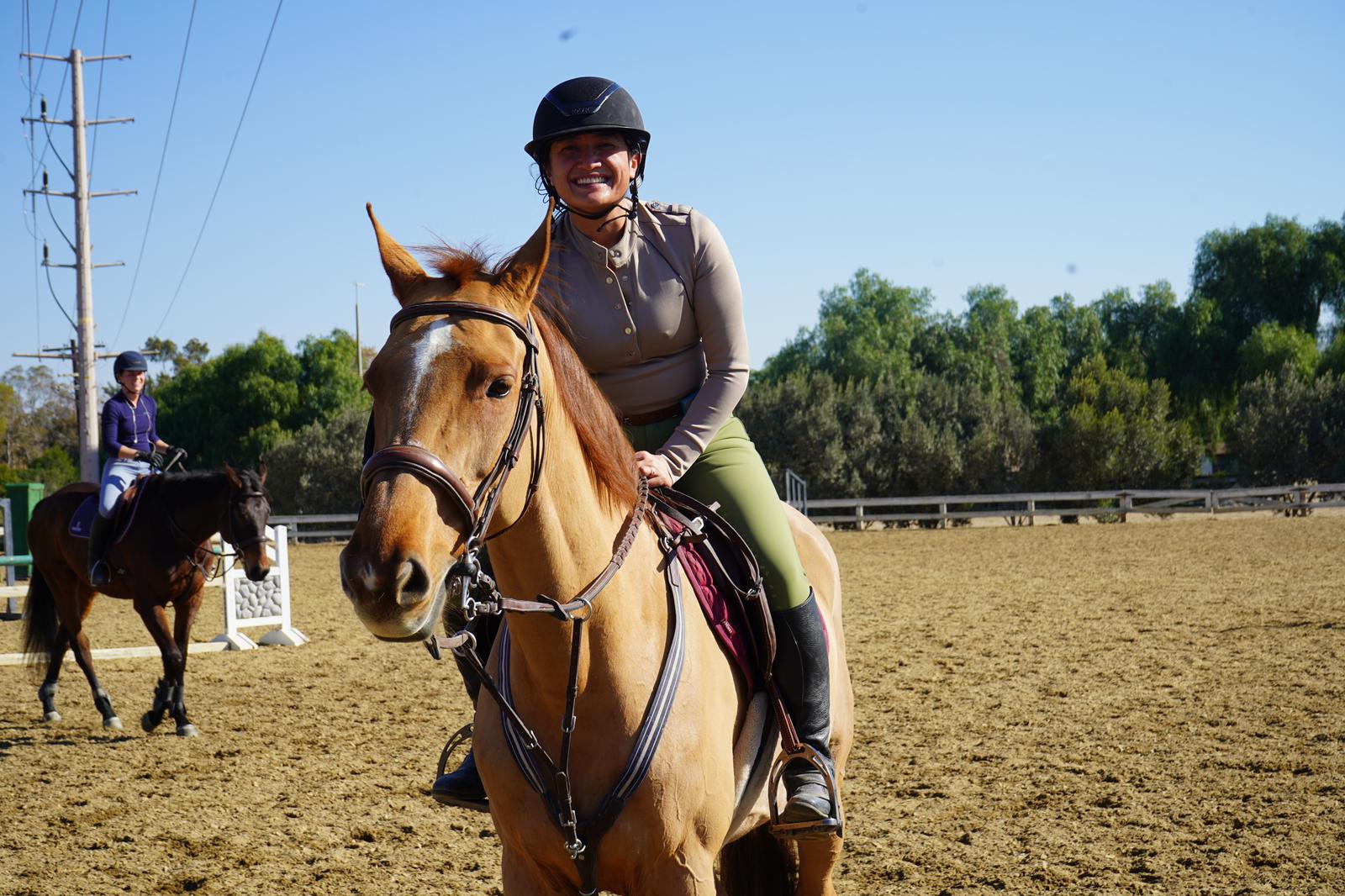 Rider smiling during a riding school lesson at Hegewisch Stables
