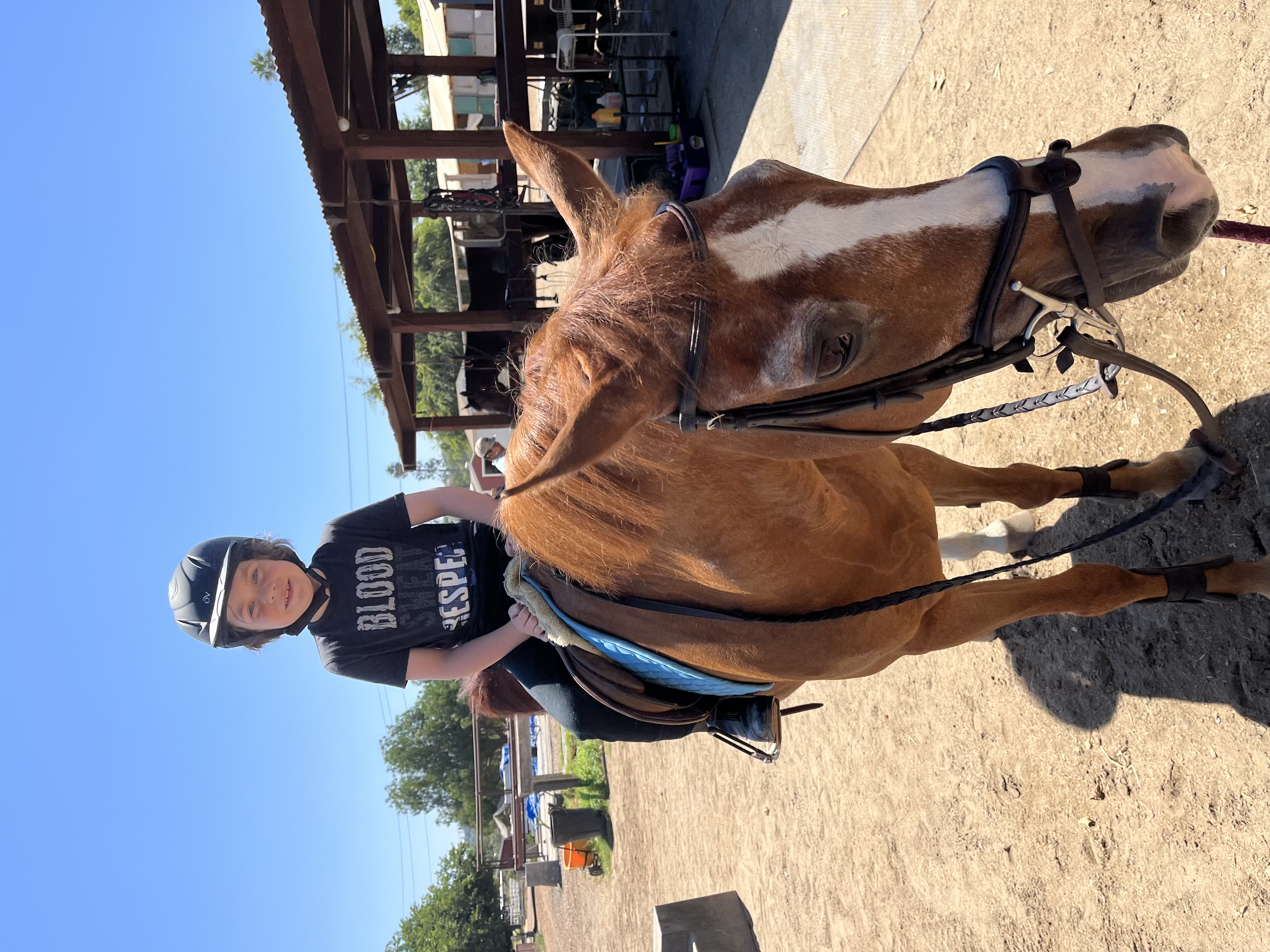 Child riding horse at camp